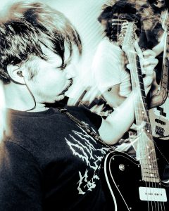 black and white image of two men performing with guitars