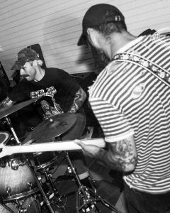 black and white photo of the drummer and guitar player of Axe Collector