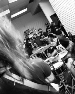 black and white image of band members and attendees at an Axe Collector concert at the Mystery Shop