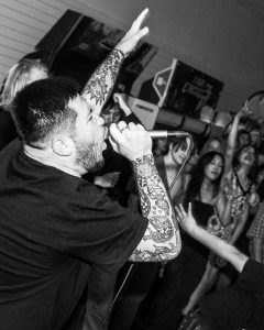 black and white photo of the singer of Last Remorse performing at the Mystery Shop