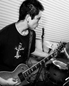 black and white photo of guitar player from Suicide Revolver