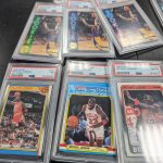 Six graded Michael Jordan basketball trading cards in acrylic cases. Three of the cards are rookie cards.
