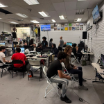 A crowd of young men playing video games in a tournament at the Mystery Shop in Oxnard, CA