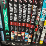 A shelf of manga, including Jojo's Bizarre Adventure Part 1 #2, Jujutsu Kaisen, and Kaiju No 8.
