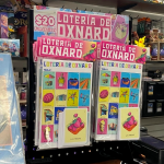 A hanging display for loteria cards. The sign reads: "Loteria de Oxnard. $20 Fundraiser."